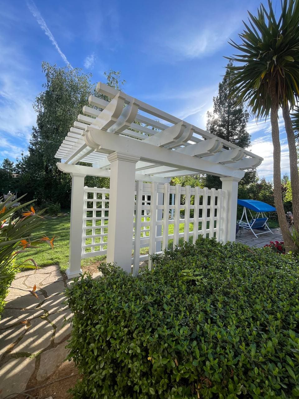 Custom freestanding white aluminum lattice pergola with corbel ends and privacy trellis in Roseville, CA.