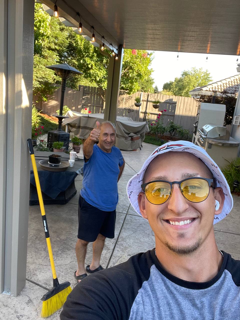 Vlad Bilous talking with a happy customer in front of a newly installed aluminum patio cover