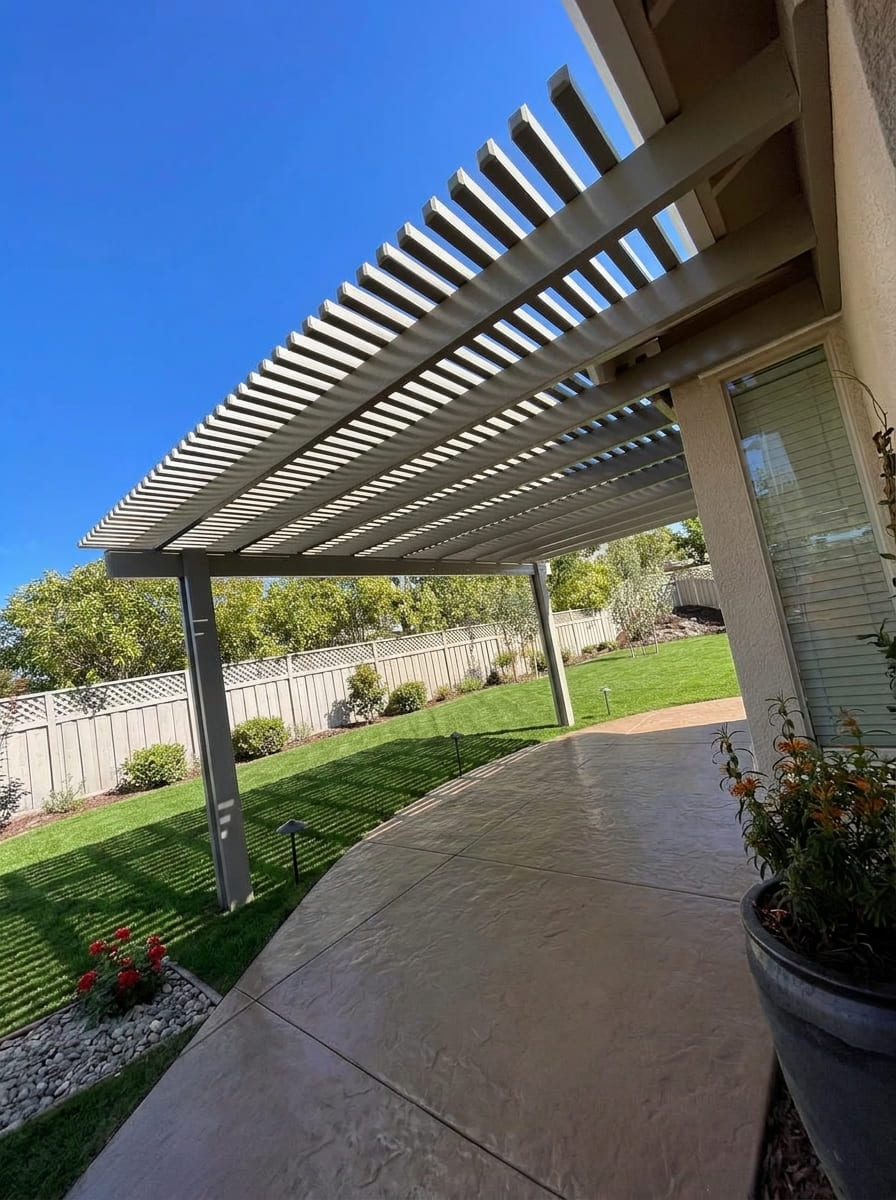 Attached aluminum lattice pergola patio cover providing filtered shade in Rocklin, CA.