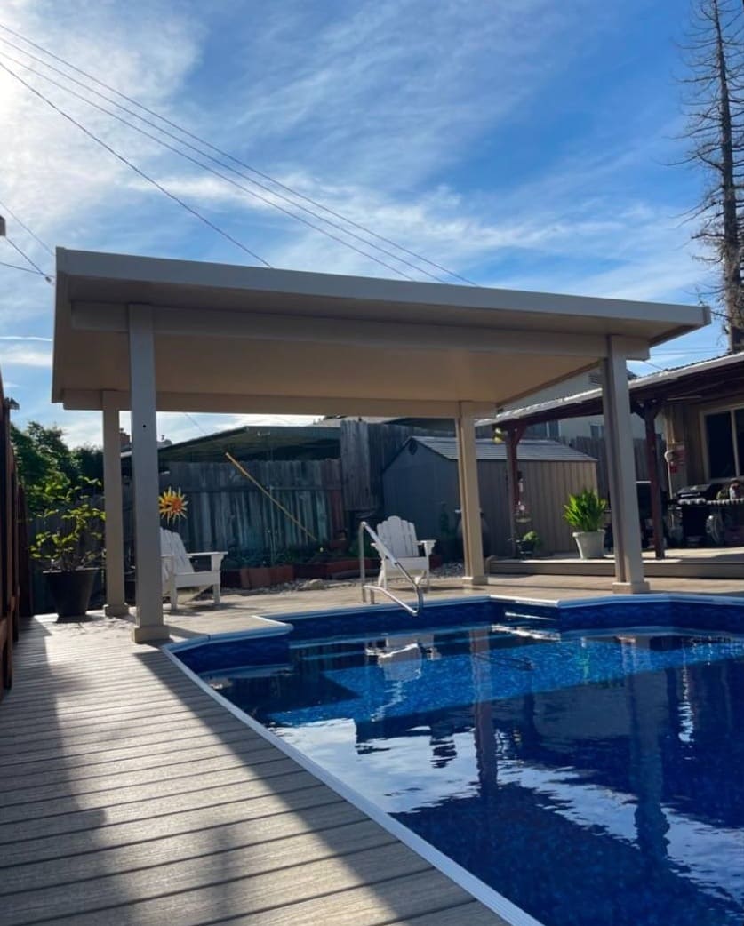 Custom freestanding solid insulated aluminum patio cover cabana installed on a poolside deck with lounge chairs in Citrus Heights, CA.